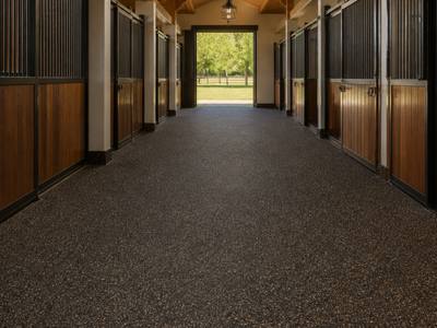 Barn aisle finished in brown rubber surfacing
